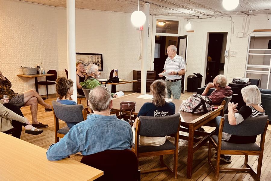 A community meeting at the loft, with neighbors seated around tables